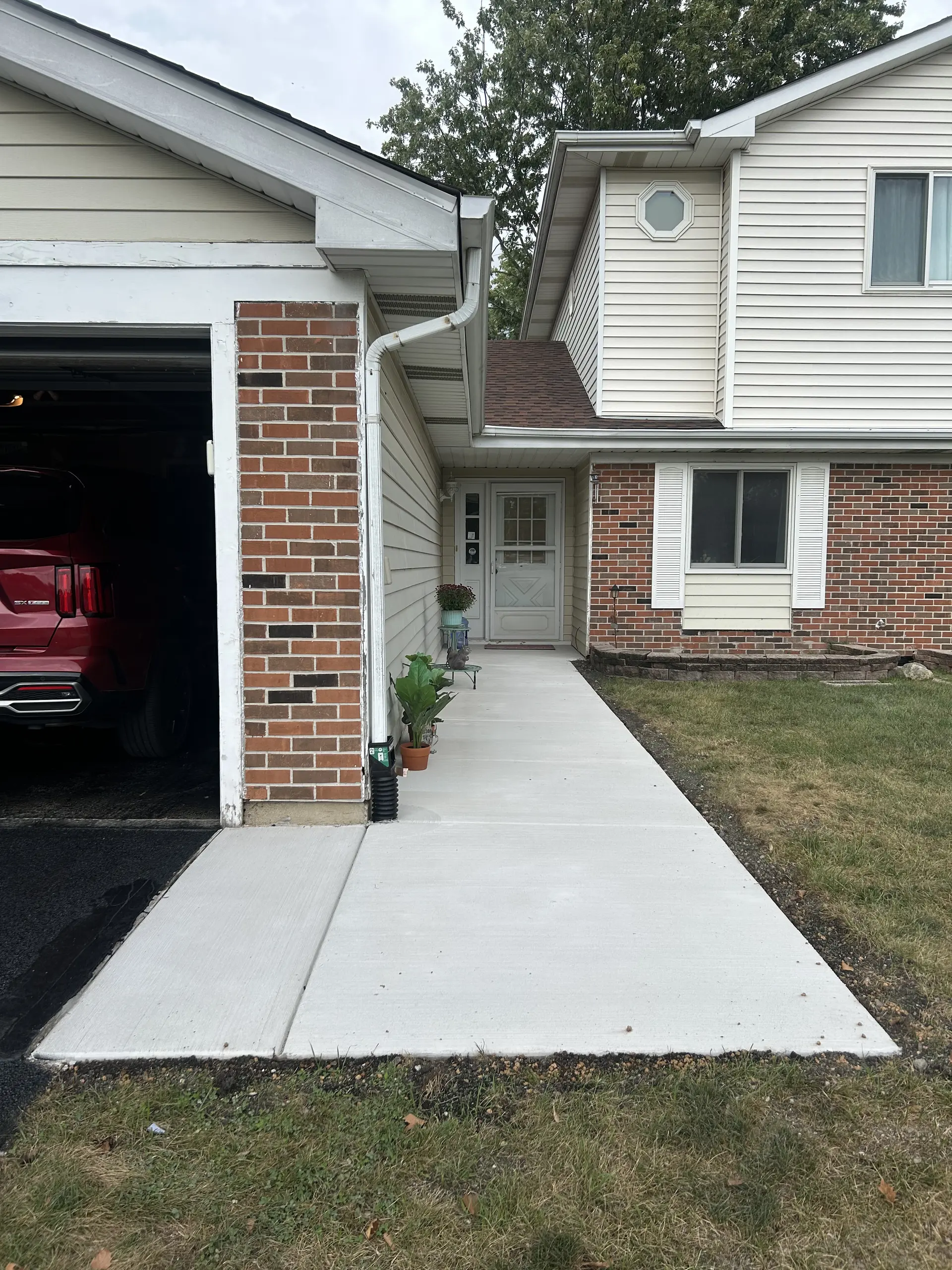 Smooth broom-finished concrete driveway by FPI Construction