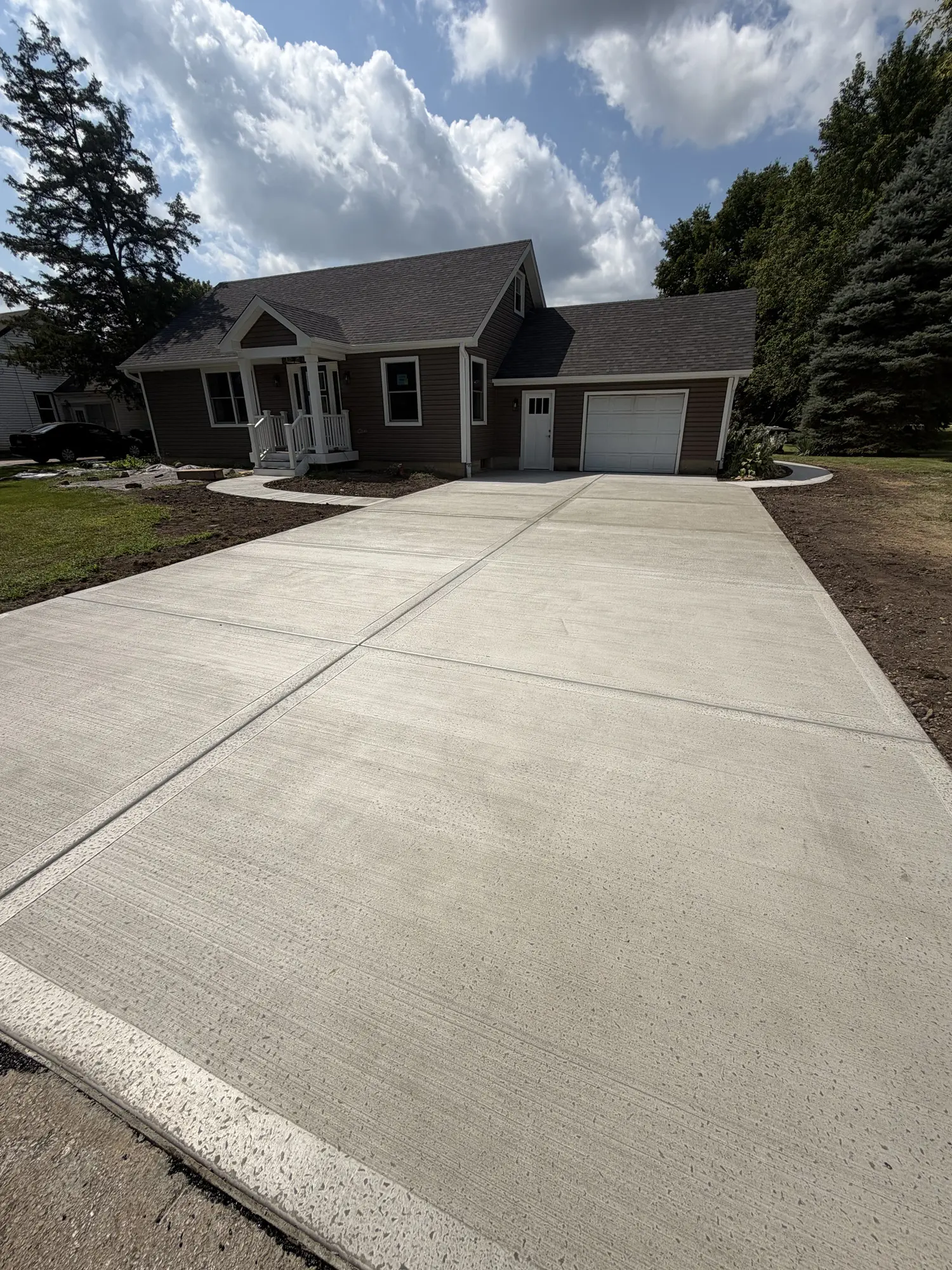 Wide concrete driveway poured by FPI Construction